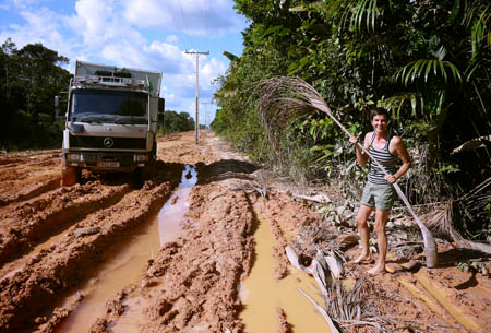 Using palm leaves to drive mud road